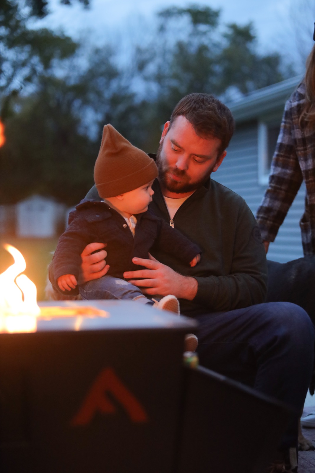 A father and baby in firelight