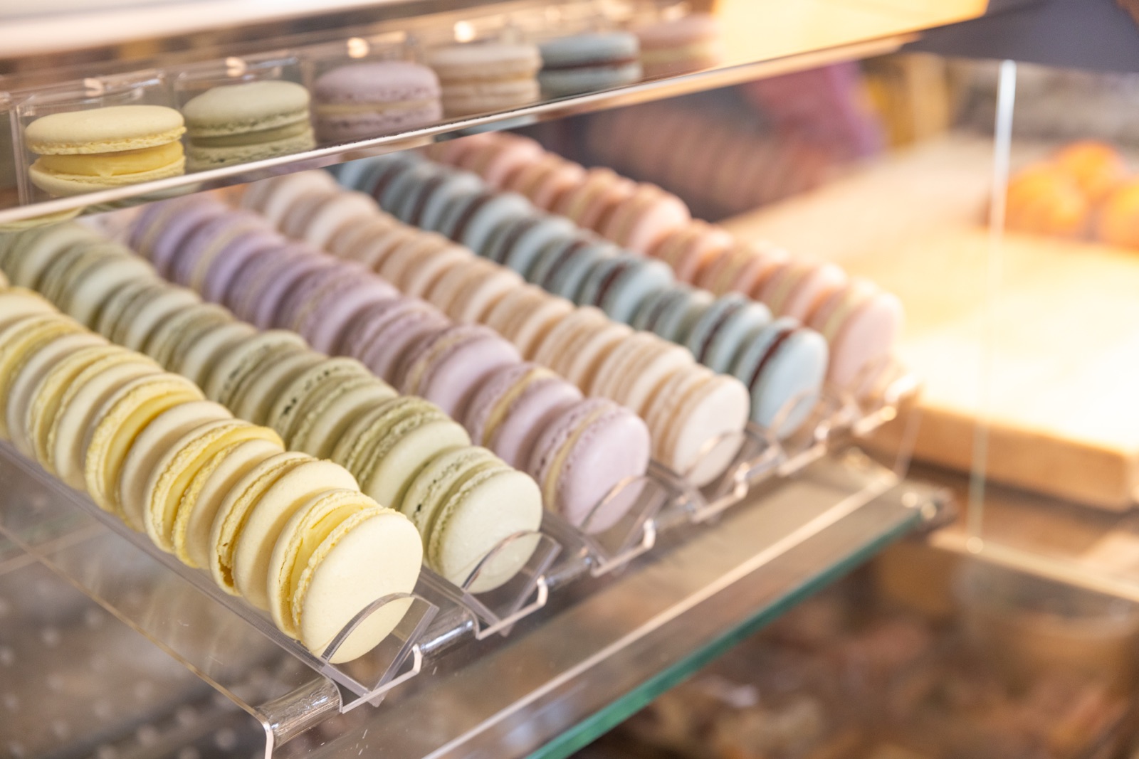 A tray of macarons in a patisserie case