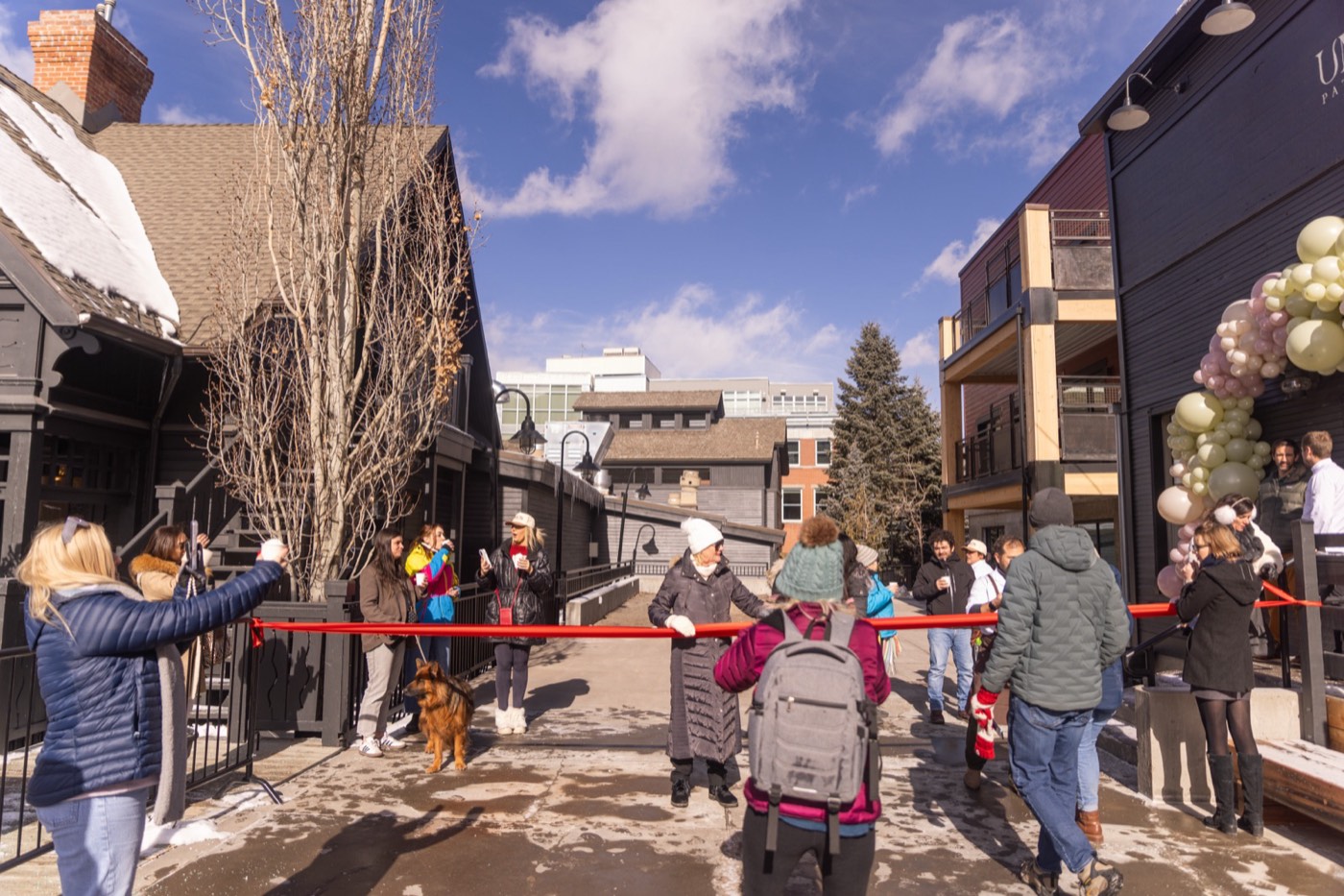 A ribbon cutting on a snowy main street