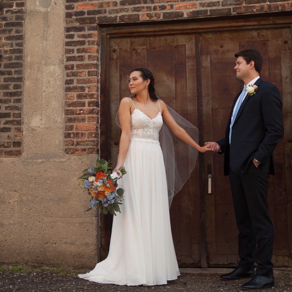A bride and groom on a city street