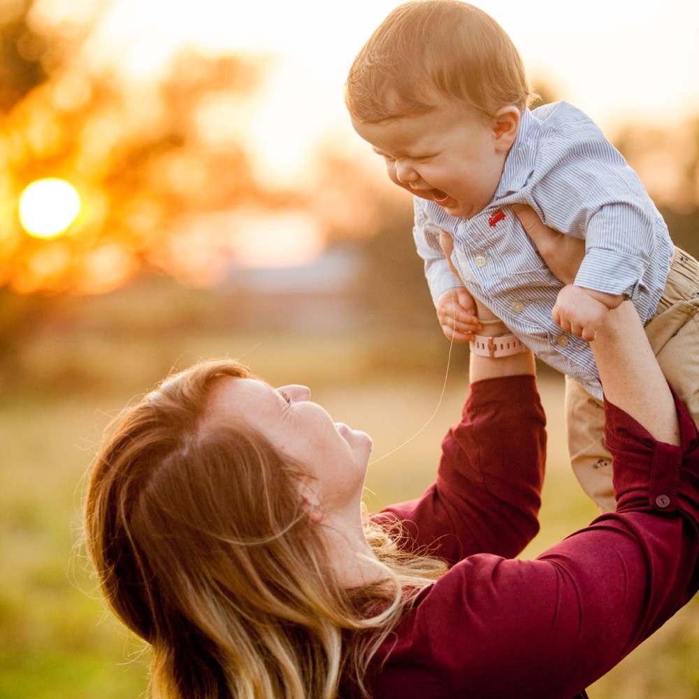 A parent lifting a child in the air