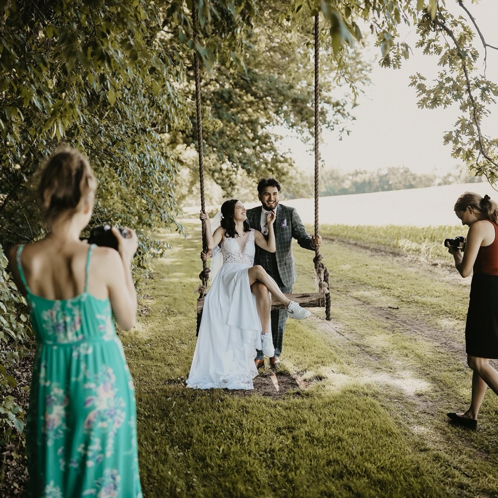 A couple on a swing at their wedding
